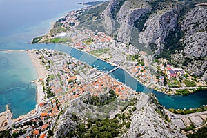 Aerial view of the coastline with vibrant houses and buildings on the rocky hills overlooking ocean