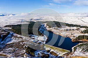 Aerial view of a cold, snow covered winter town with semi frozen lakes and ponds