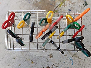 An aerial view of a collection of classroom scissors in a rack