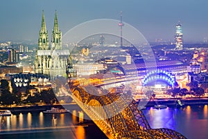 Aerial view of Cologne Cathedral and Hohenzollern Bridge at dusk