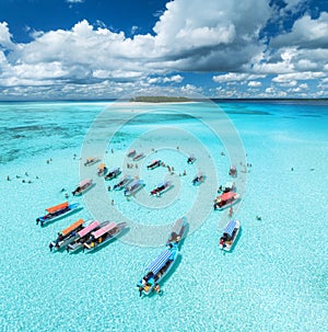 Aerial view of colorful boats, sandbank, blue sea on sunny day