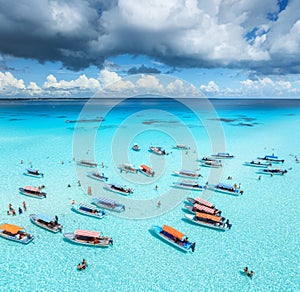 Aerial view of colorful boats, sandbank, blue sea on sunny day