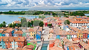 Aerial view of colorful Burano island houses in Venetian lagoon sea from above, Italy