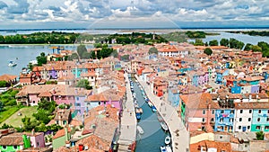 Aerial view of colorful Burano island houses in Venetian lagoon sea from above, Italy