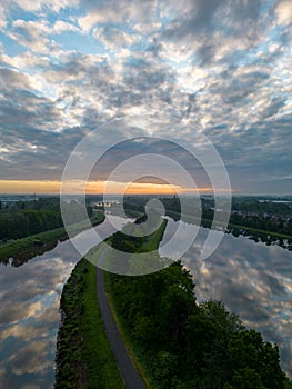 Aerial view of a colorful dramatic sunrise sky over the river Nete in Duffel, Belgium. River with water for transport
