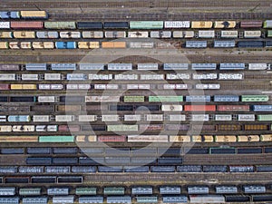 Aerial view of colorful freight trains on the railway station.