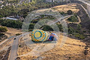 Aerial view of colorful hot air balloons preparation for launch over San Diego