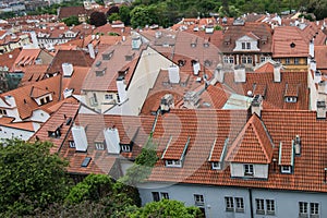 Aerial view of the colorful orange roofs of old houses in the city of Europe Prague