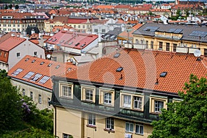 Aerial view of the colorful orange roofs of old houses in the city of Europe Prague