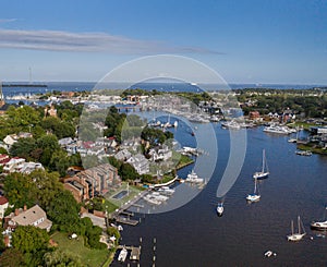 Aerial view of colorful sailboat moorings and docks surrounded by colorful residential rooftops on and azure blue Spa Creek, in hi