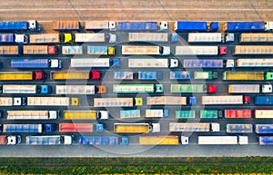Aerial view of colorful trucks in terminal at sunset in summer
