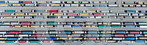 Aerial view of colorful trucks in the terminal waiting for unloading. Top view of the logistics center.