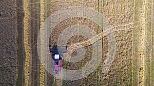 Aerial view combine harvester harvesting on the field. Harvesting wheat. Harvester machine working in field