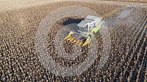 Aerial view combine harvester harvesting on sunflower field. Mechanized harvesting sunflower