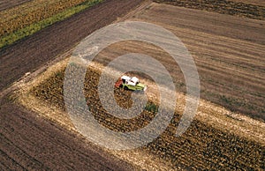 Aerial view of combine harvesting corn field