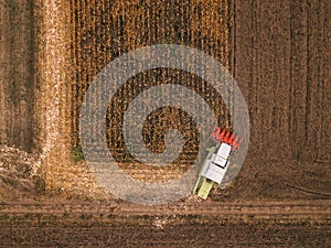 Aerial view of combine harvesting corn field