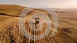 Aerial view of combine harvesting at sunset