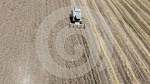 Aerial view of combine harvesting wheat in the field