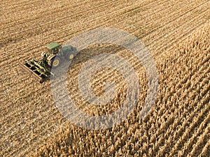 Aerial view on the combine working on the large corn field