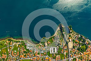 Aerial view of Como lake, Dongo, Italy. Coastline is washed by blue turquoise water.