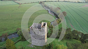 Aerial view of Conna Castle in county Cork, Ireland, a ruined five storey square tower house about 85 feet tall built in 1550