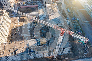 Aerial view of construction cranes and a multi-storey building under construction in a residential area of the city