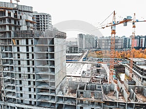 Aerial view for the construction of a residential building, tower crane. Autumn, St. Petersburg, Russia.