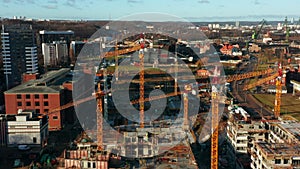 Aerial view of a construction site with cranes and heavy machinery.