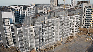 Aerial view of construction site and facade unfinished structure city block of flats. Building work process modern an