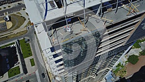 Aerial View Of Construction Site With Group Of Builders Discussing Blueprint Of Project