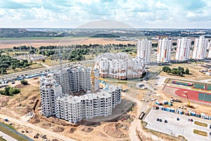 Aerial view of construction site with new modern apartment building under construction