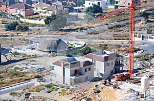 Aerial view of construction site, villas and cranes