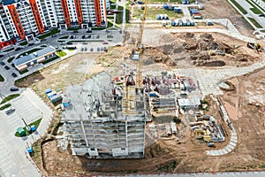 Aerial view of construction site with yellow crane and building materials