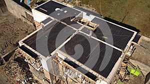 Aerial view of construction workers working on a bulding site of residential apartment house. Real estate development.