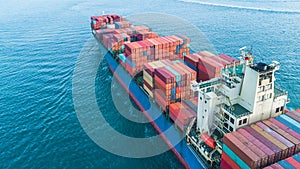 Aerial view container cargo ship, business freight shipping international by container cargo ship in the open sea.