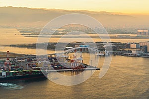 Aerial view of container cargo ship in the export and import business and logistics international goods in urban city. Shipping to