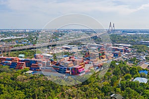 Aerial view of container cargo ship in the export and import business and logistics international goods in urban city. Shipping to