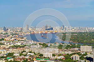 Aerial view of container cargo ship in the export and import business and logistics international goods in urban city. Shipping to