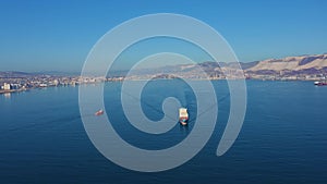 Aerial view of container ship floating with cargo from commercial sea port