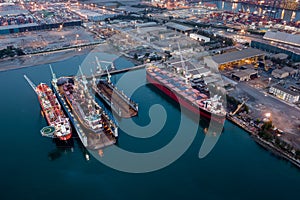 Aerial view Container ship repair in shipyard at twilight over lighting