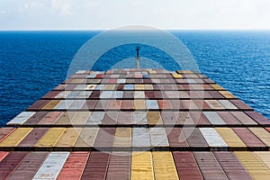 Aerial view on the containers loaded on deck of the large cargo ship.