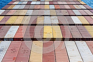 Aerial view on the containers loaded on deck of the large cargo ship.