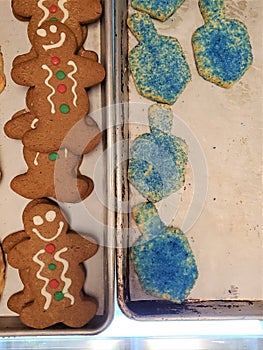 Aerial view of cookie sheets with dreidel cookies gingerbread men