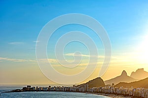 Aerial view of Copacabana beach and Rio de Janeiro mountains seen from above during summer sunset