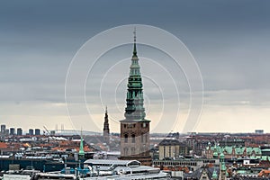 Aerial view of Copenhagen City from the The Round Tower Rundetaarn in rainy misty day with cloudy sky and Saint Nikolas church