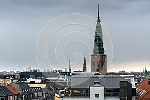 Aerial view of Copenhagen City from the The Round Tower Rundetaarn in rainy misty day with cloudy sky and Saint Nikolas church