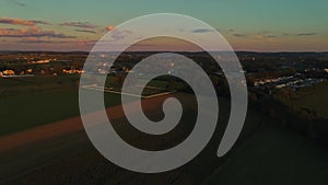 Aerial View of Corn Fields and Fertile Farmlands and Farms at a Golden Hour Sunset