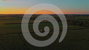 Aerial View of Corn Fields and Fertile Farmlands and Farms at a Golden Hour Sunset