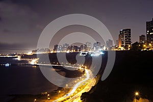l view of costa verde bajada armendariz modern and luxurious buildings at night miraflores beaches lima peru photo