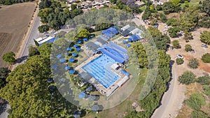 Aerial view of a country club with blue swimming pool